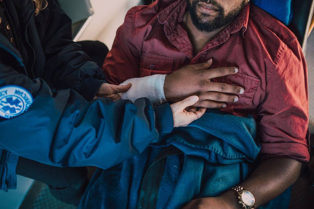 Paramedic tending to an injured person's arm