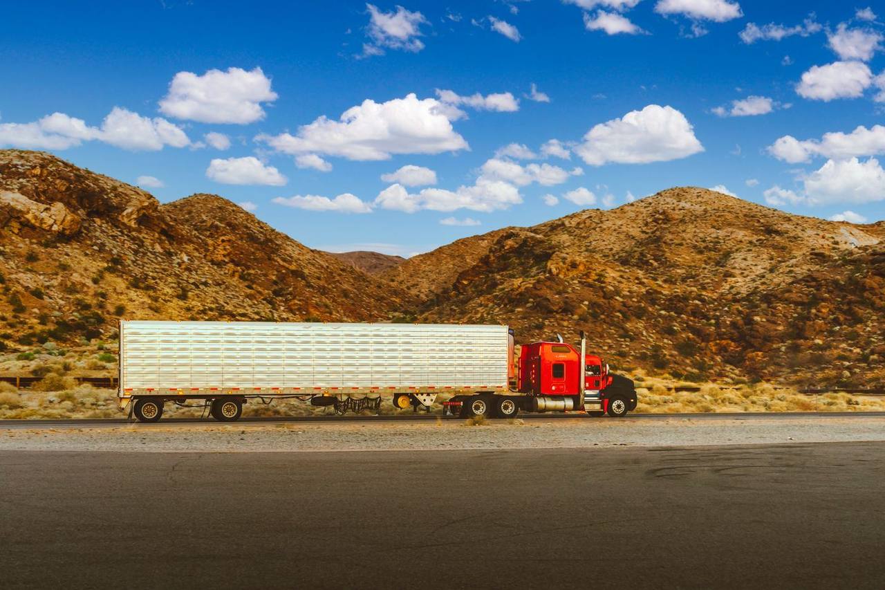 A semi-truck traveling on an open highway